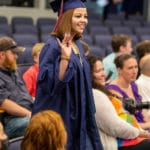 Graduate entering graduation by audience
